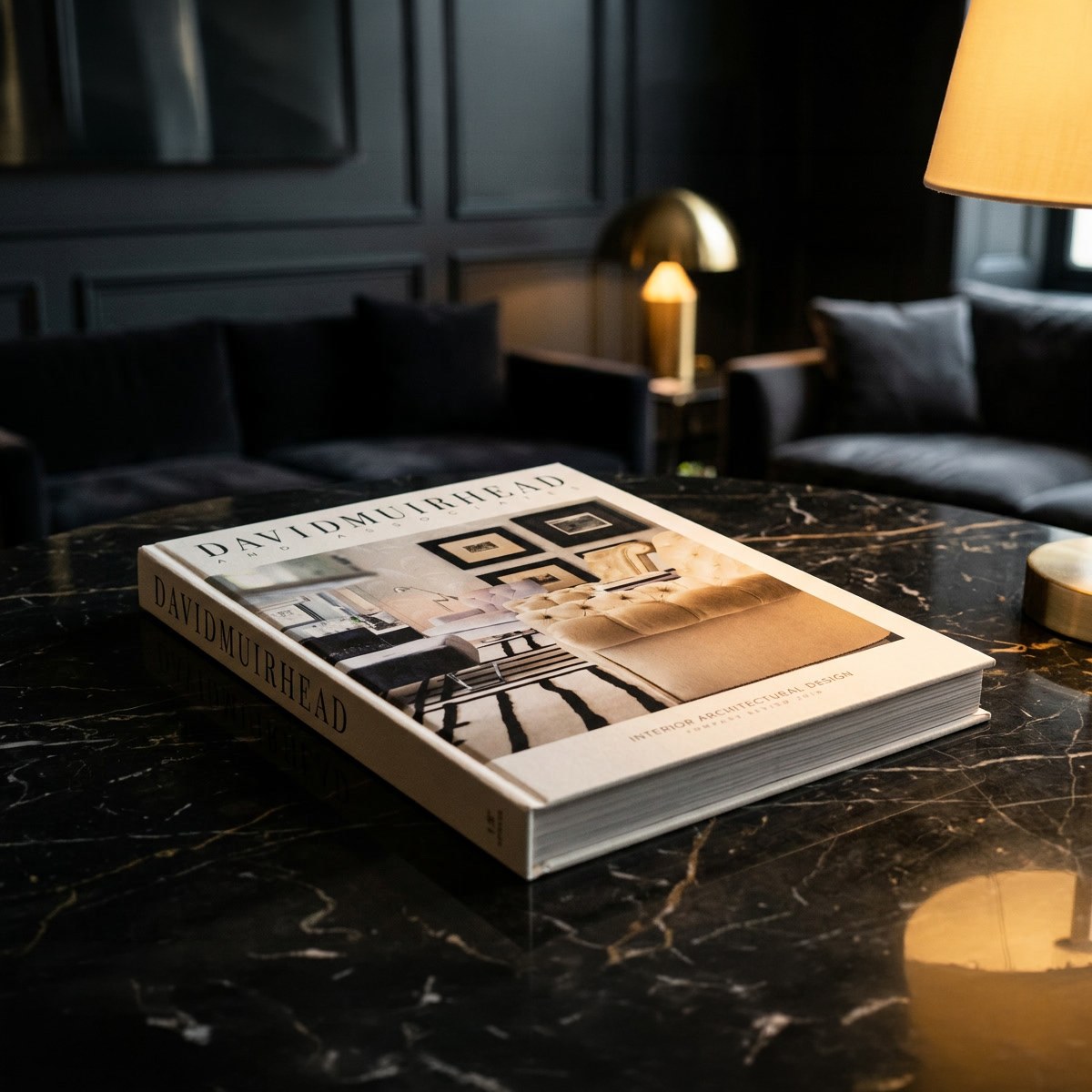The David Muirhead monograph closed on a marble table in a low-lit lounge.