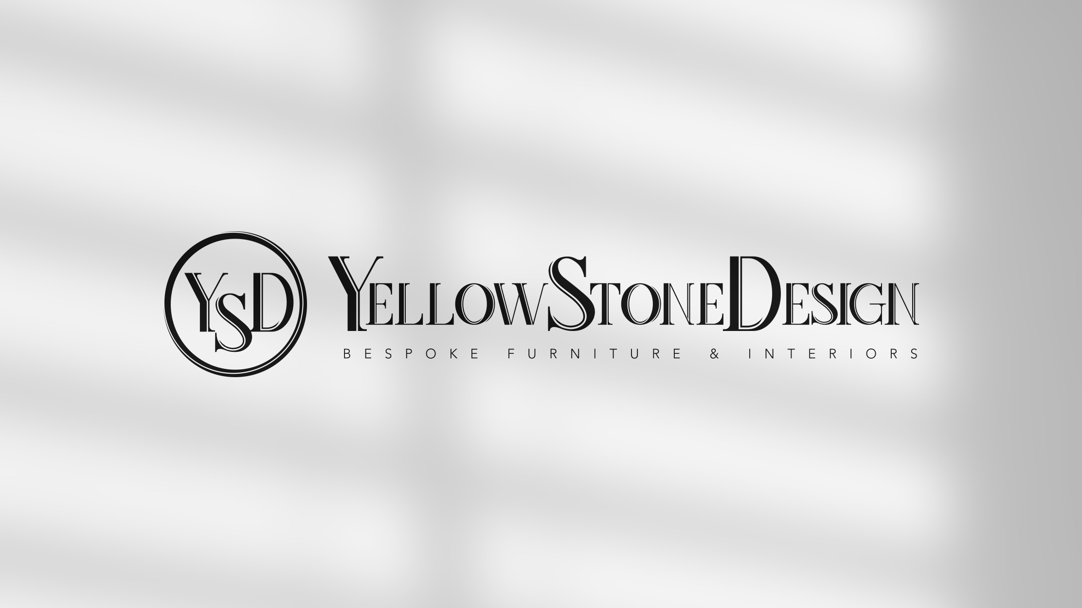 The YellowStone Design lockup on a pale wall in window light: the YSD monogram in its circle beside the wordmark, with the line Bespoke Furniture and Interiors beneath.